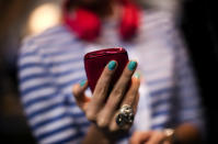 A woman holds a new model of Nokia mobile phone.