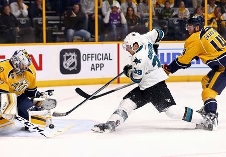 San Jose Sharks center Logan Couture (39) attempts a shot against Nashville Predators goalie Pekka Rinne (35) while being defended by Nashville Predators defenseman Mattias Ekholm (14) during the overtime period in game four of the second round of the 2016 Stanley Cup Playoffs at Bridgestone Arena. Mandatory Credit: Aaron Doster-USA TODAY Sports