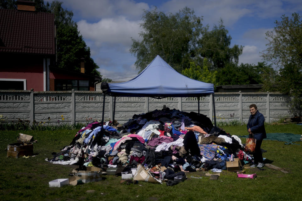 A woman stands outside a Church to receive clothing in Borodyanka, on the outskirts of Kyiv, Ukraine, Tuesday, May 31, 2022. (AP Photo/Natacha Pisarenko)