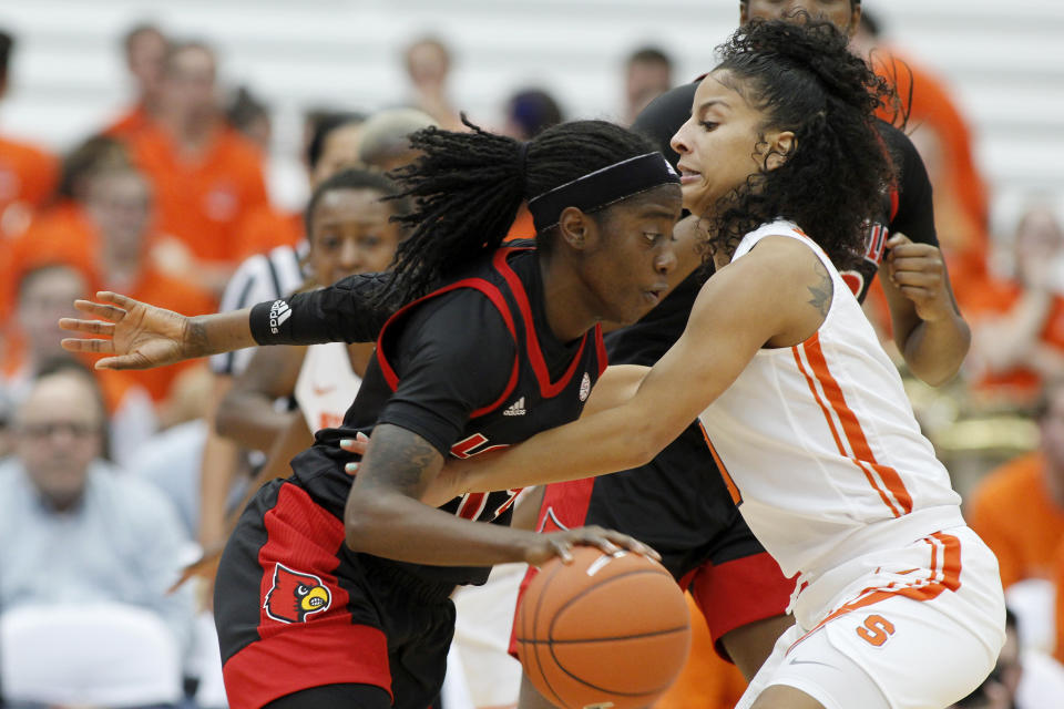 Louisville's Jazmine Jones, left, dribbles into Syracuse's Elemy Colom'e, right, in the first quarter of an NCAA college basketball game in Syracuse, N.Y., Sunday, Feb. 9, 2020. (AP Photo/Nick Lisi)