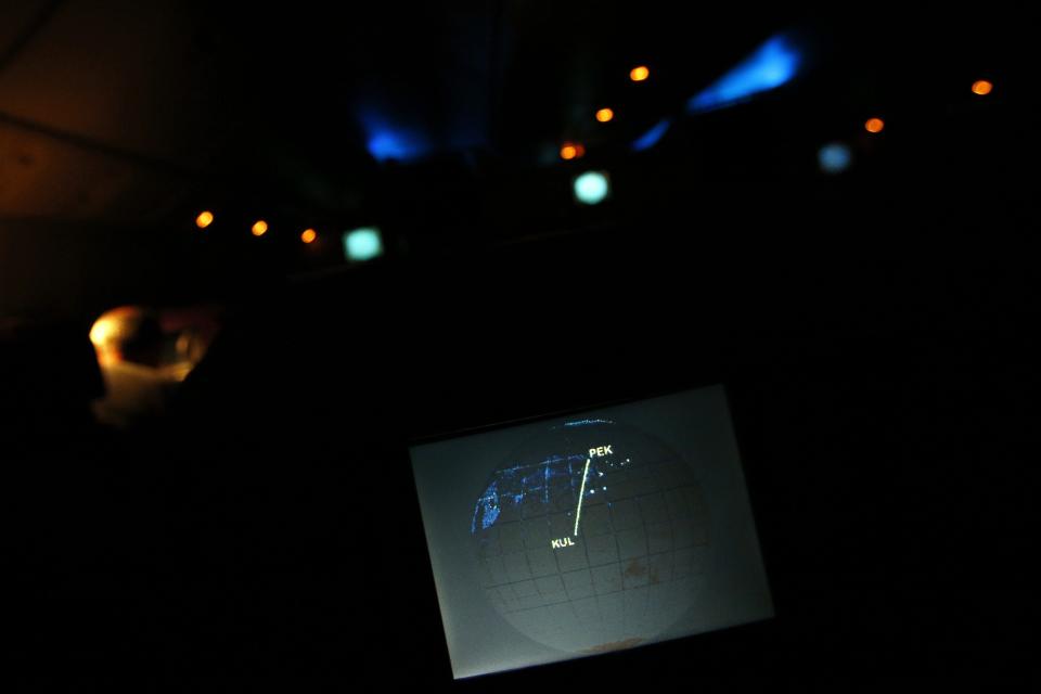 A screen on board Malaysia Airlines Boeing 777-200ER flight MH318 shows the plane's flight path as it cruises over the South China Sea