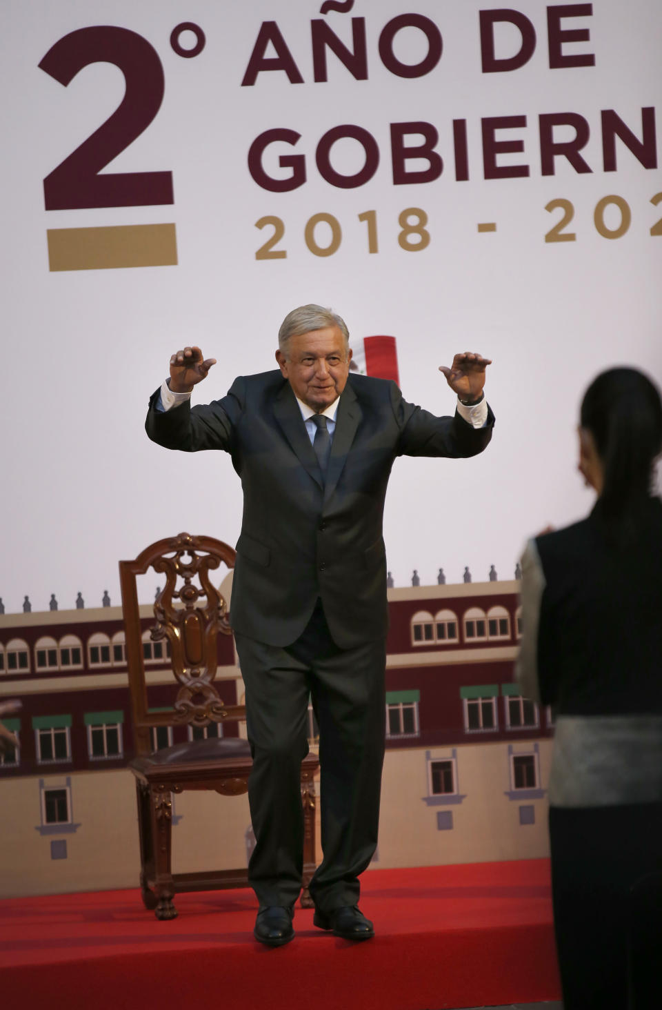 Mexican President Andres Manuel Lopez Obrador raises his arms after a speech during the commemoration of his second anniversary in office, at the National Palace in Mexico City, Tuesday, Dec. 1, 2020. (AP Photo/Marco Ugarte)