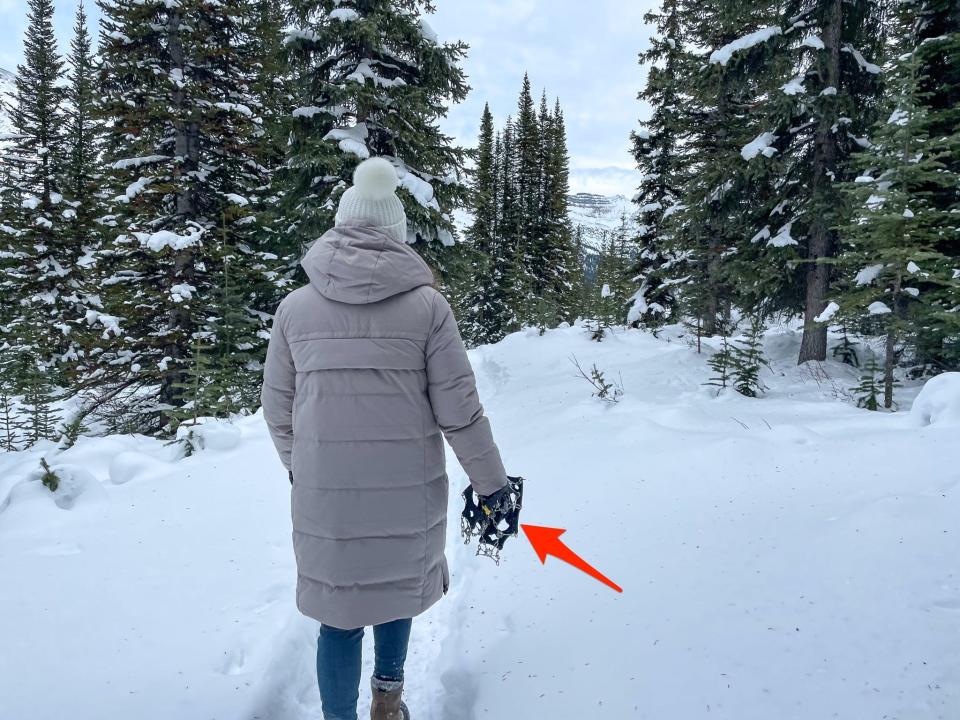My friend holds a pair of microspikes, which we didn't end up using on our snow hike.