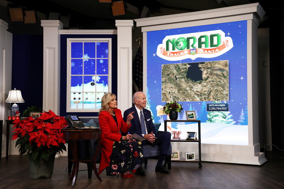 President Joe Biden and first lady Dr. Jill Biden participate in an event to call NORAD and track the path of Santa Claus on Christmas Eve in the South Court Auditorium of the Eisenhower Executive Building on Dec. 24, 2021.<span class="copyright">Alex Wong—Getty Images</span>