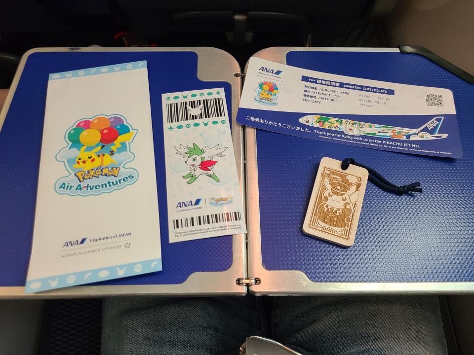 Souvenir items on Pokemon flight on tray table 