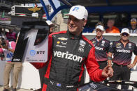 Will Power, of Australia, holds the trophy after winning the pole for the IndyCar auto race at Indianapolis Motor Speedway, Friday, May 13, 2022, in Indianapolis. (AP Photo/Darron Cummings)
