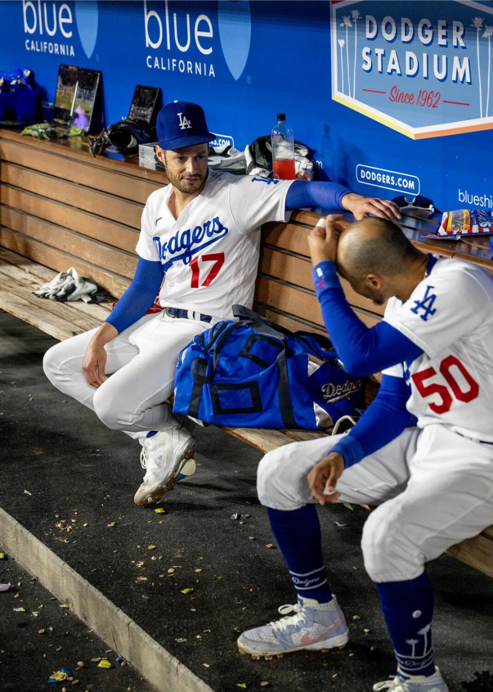 Joe Kelly and Mookie Betts chat in the dugout.