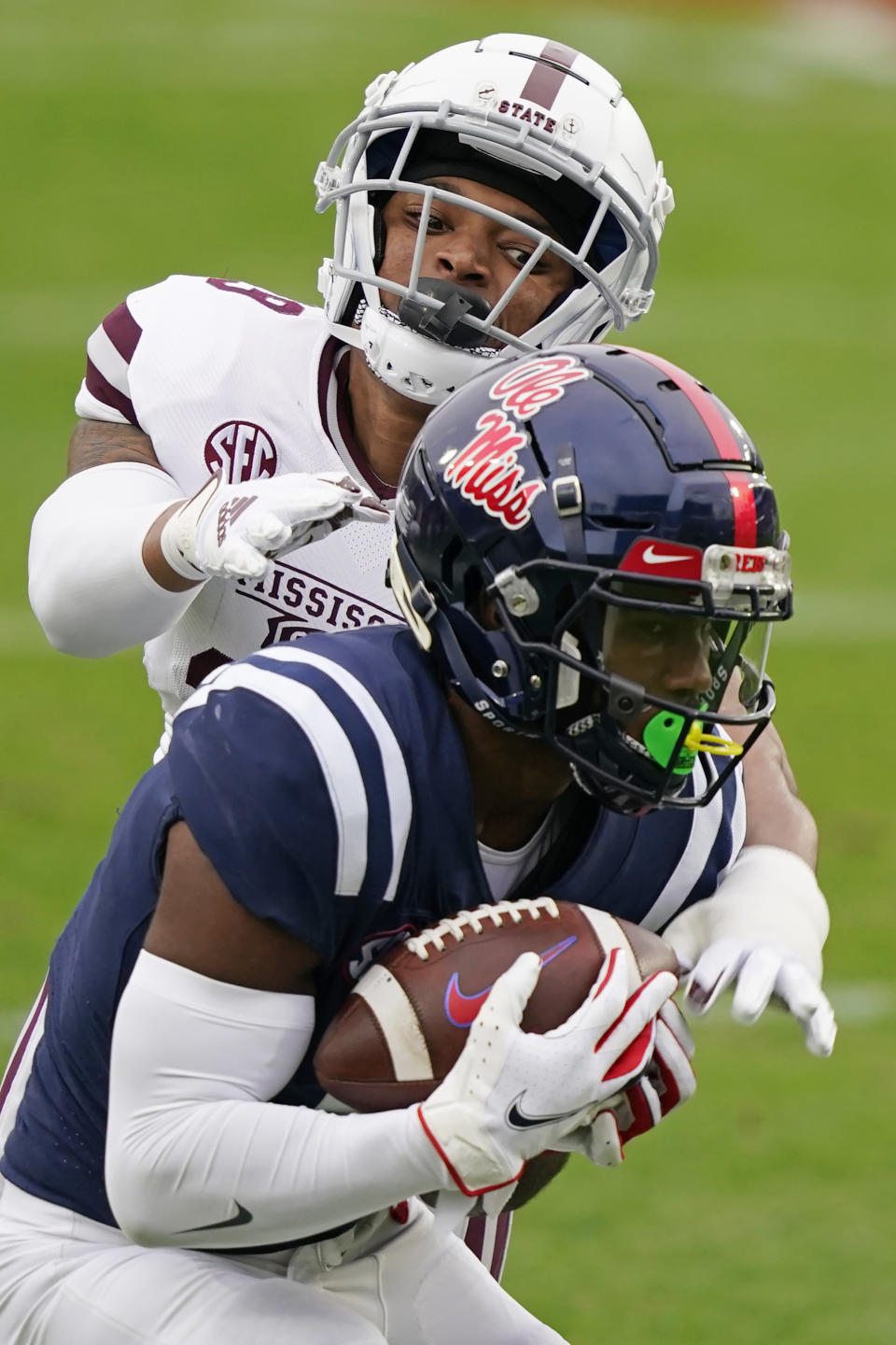 Mississippi wide receiver Elijah Moore (8) catches a pass in front of Mississippi State safety Collin Duncan during the first half of an NCAA college football game, Saturday, Nov. 28, 2020, in Oxford, Miss. Mississippi won 31-24. (AP Photo/Rogelio V. Solis)