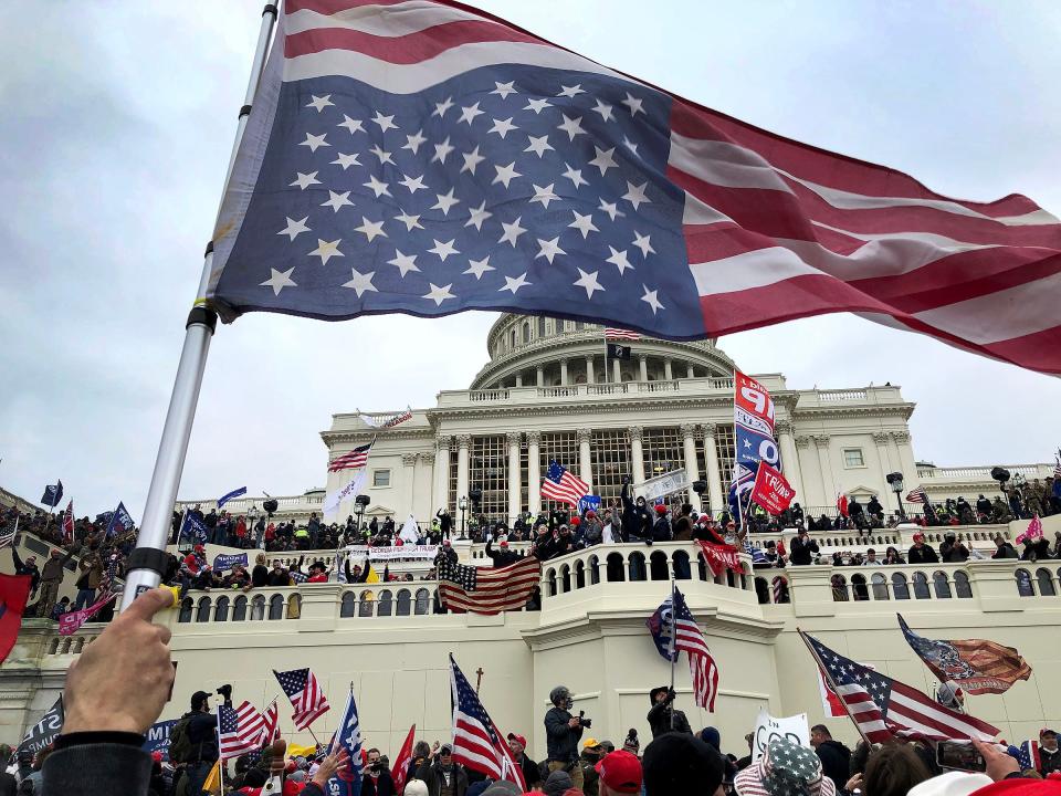 An upside-down American flag became a signal of election denial as pro-Trump protesters stormed the U.S. Capitol on Jan. 6, 2021.