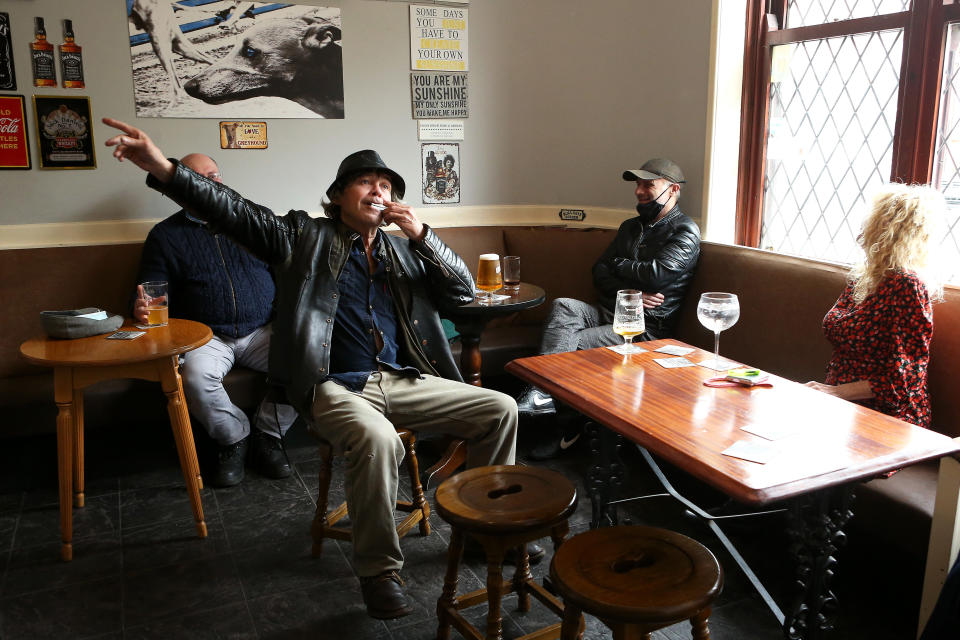 BOLTON, ENGLAND - MAY 17: A man is seen playing a harmonica while enjoying a pint in The Greyhound Pub as indoor hospitality reopens on May 17, 2021 in Bolton, England. UK Health Secretary Matt Hancock said during a TV interview yesterday that a the government will consider a local lockdown in Bolton 