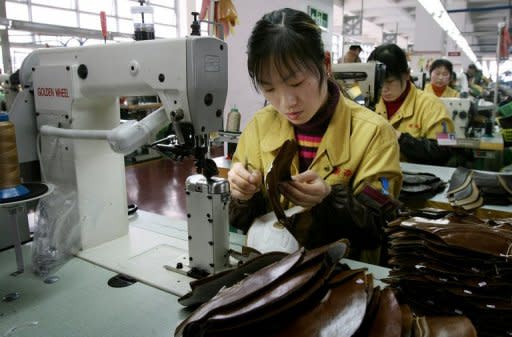 This file photo shows a factory worker stitching leather shoe uppers on a production line at a shoe factory in the Chinese city of Wenzhou, in 2006. Rapid wage increases are threatening China's competitiveness, but improved productivity and other advantages mean it will continue to attract investors, analysts say