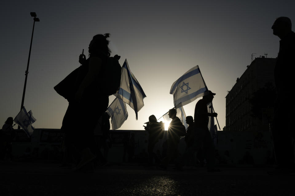 People take part in a protest against Israeli Prime Minister Benjamin Netanyahu's government and call for the release of hostages held in the Gaza Strip by the Hamas militant group outside of the Knesset, Israel's parliament, in Jerusalem, Sunday, March 31, 2024. Tens of thousands of Israelis gathered outside the parliament building in Jerusalem on Sunday, calling on the government to reach a deal to free dozens of hostages held by Hamas and to hold early elections. (AP Photo/Leo Correa)