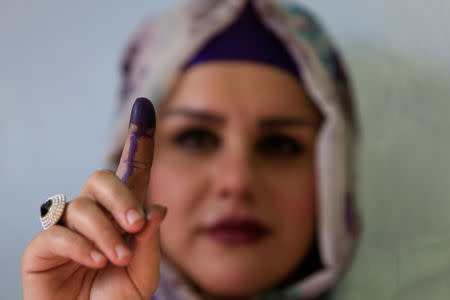 A woman shows her ink-stained finger during Kurds independence referendum in Halabja, Iraq September 25, 2017. REUTERS/Alaa Al-Marjani