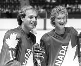 Montreal Canadiens' Guy Lafleur, left, and Edmonton Oilers' Wayne Gretzky are seen during a break in their light skate at the first day of training camp for Team Canada in Montreal, Aug. 10, 1981. Montreal Canadiens legend Guy Lafleur has died at age 70. (Ian MacAlpine/The Canadian Press via AP)