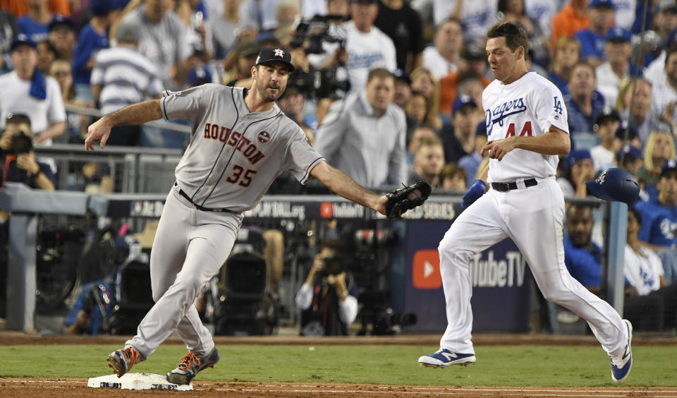 <p>Houston Astros starting pitcher Justin Verlander (35) tags out Los Angeles Dodgers starting pitcher Rich Hill (44) in the third inning in game two of the 2017 World Series at Dodger Stadium. Mandatory Credit: Robert Hanashiro-USA TODAY Sports </p>