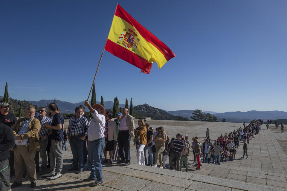 In this Saturday, Oct. 5, 2019 photo, visitors queue to enter at the Valley of the Fallen mausoleum near El Escorial, outskirts of Madrid, Spain, Saturday, Oct. 5, 2019. After a tortuous judicial and public relations battle, Spain's Socialist government has announced that Gen. Francisco Franco's embalmed body will be relocated from a controversial shrine to a small public cemetery where the former dictator's remains will lie along his deceased wife. (AP Photo/Bernat Armangue)