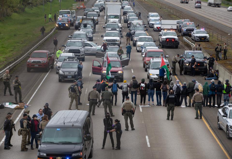 Protesters in Oregon are arrested as they block the southbound lane of Interstate 5 between Eugene and Springfield on Monday, April 15, 2024.