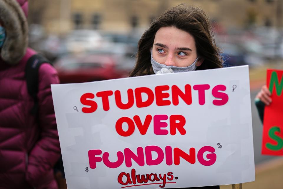 Round Rock High School junior Jade Carrico participates Thursday in a walkout at the school to demand stricter COVID-19 protocols amid rising cases among students and faculty.