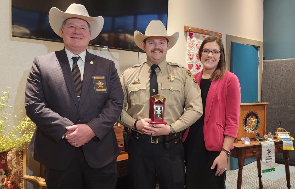 Amarillo Rotary South's Randall County Deputy of the Year, Matt Mitchell, center, stands with his wife, Emily, and Randall County Sheriff Chris Forbis Thursday morning at a presentation at the Ronald McDonald House in Amarillo.