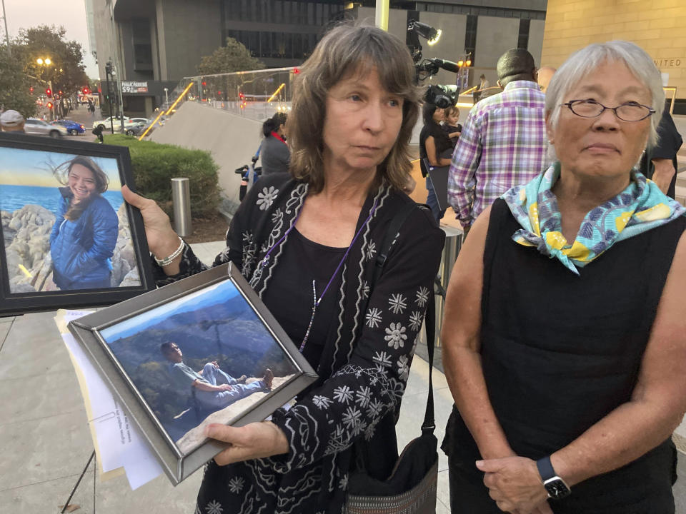 Vicki Moore, left, and Barbara Chan, sister, hold a photo of Vicki's husband and daughter Scott Chan, and daughter Kendra Chan, who died aboard the dive boat Conception at Santa Cruz Island, at federal court in Los Angeles, Monday, Nov. 6, 2023. A federal jury found that scuba dive boat captain Jerry Boylan was criminally negligent in the deaths of 34 people killed in a fire aboard the vessel in 2019, the deadliest maritime disaster in recent U.S. history. (AP Photo/Stefanie Dazio)