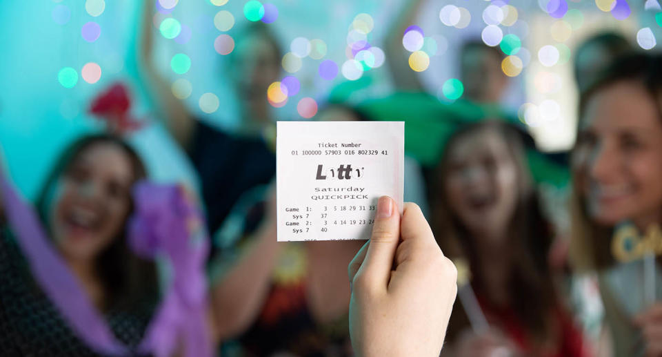 Women celebrating as another woman holds up winning Lotto ticket. Source: The Lott