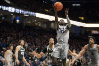 Xavier guard Souley Boum (0) shoots during the first half of an NCAA college basketball game against Providence, Wednesday, Feb. 1, 2023, in Cincinnati. (AP Photo/Jeff Dean)
