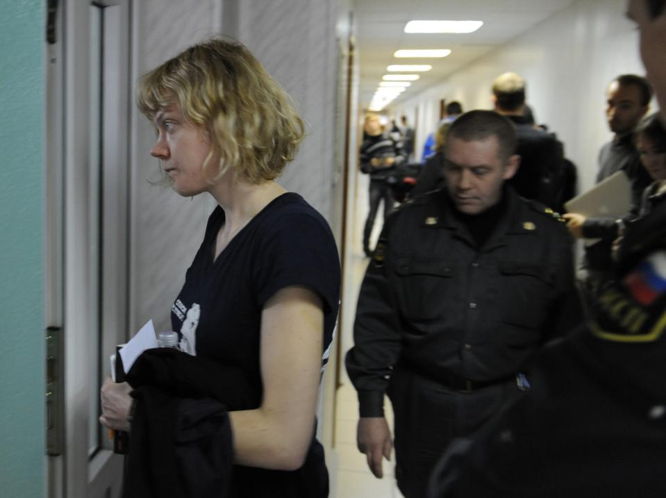 Greenpeace activist Sini Saarela from Finland is escorted at a district court in Murmansk