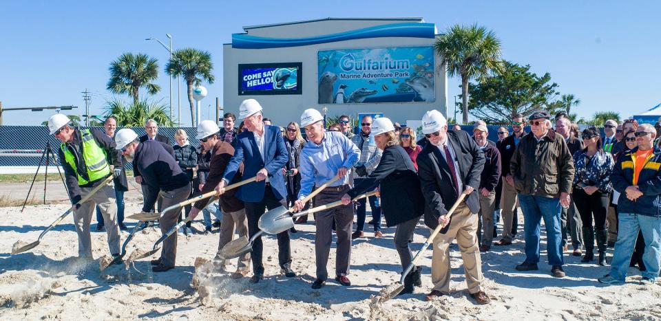 Dignitaries Chance Barnes, Jacob Dumlar, Eric Navarre, Collier Merrill, Patrick Berry, Jane Merrill and William Merrill III toss their ceremonial shovels of sand during a groundbreaking ceremony for the new Dolphin Oasis feature at the Gulfarium Marine Adventure Park on Okaloosa Island. The oasis will integrate with existing attractions, as well as the Gulfarium's rehabilitation and conservancy missions.