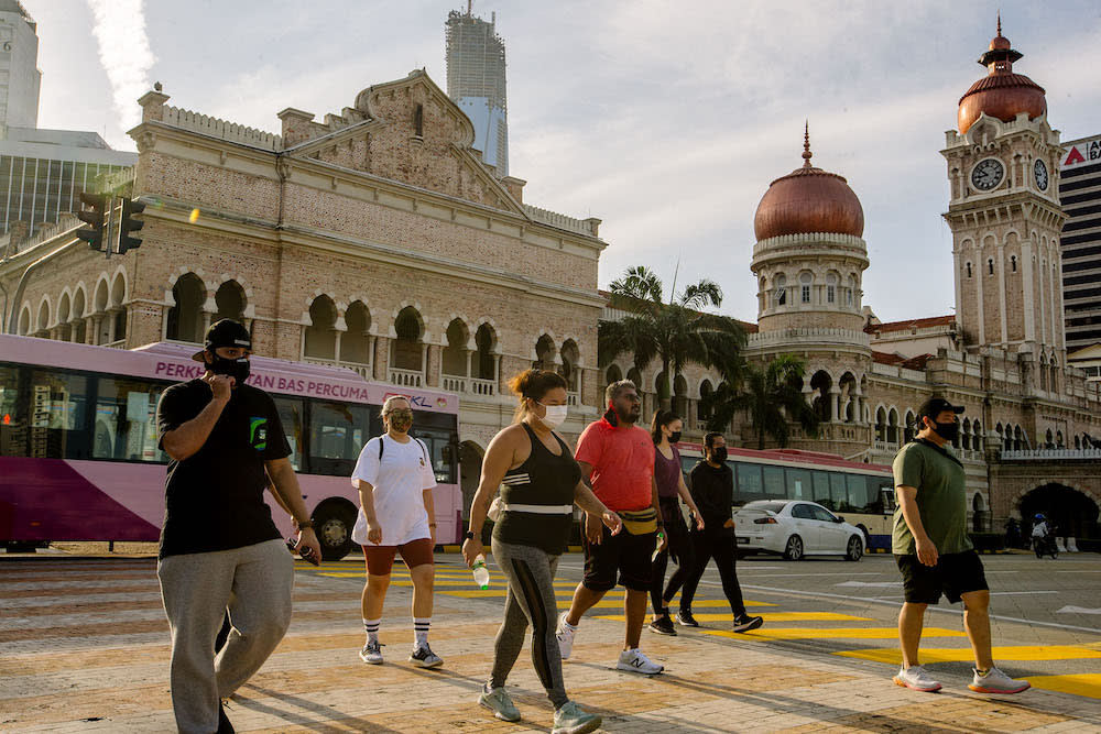 People wearing face masks are seen in Dataran Merdeka, Kuala Lumpur February 21, 2021. — Picture by Firdaus Latif