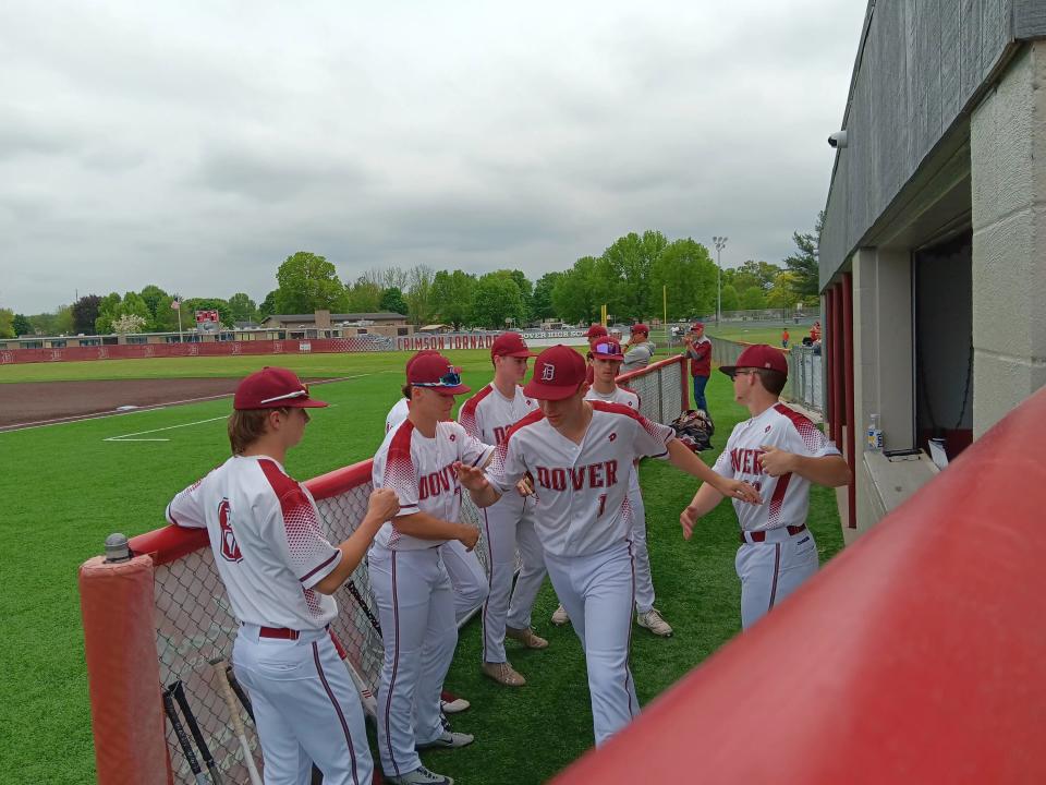 Dover's Zane Conner (1) is introduced as a starter as his teammates cheer him on during pregame ceremonies before Monday night's high school baseball game between the Crimson Tornadoes and Canton Central Catholic at Dover City Park.