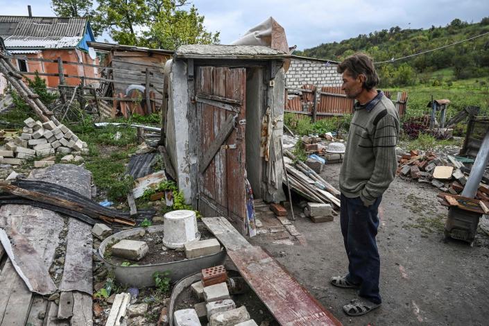 Man stands in front of a destroyed house in Bohorodychne village in Kramatorsk, Donetsk region, on 13 September 2022, amid the Russian invasion of Ukrain (AFP via Getty Images)