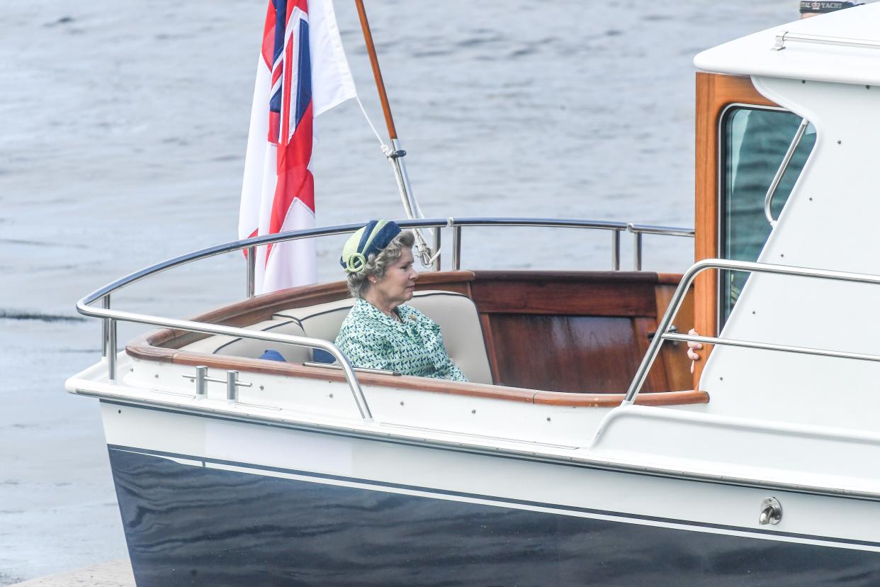 Imelda Staunton is seen on a boat made to look like a royal yacht tender in the harbor during filming for the Netflix series "The Crown" on Aug. 2, 2021, in Macduff, Scotland.