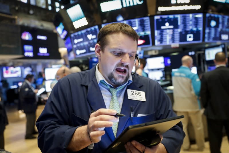 FILE PHOTO: Traders work on the floor of the NYSE in New York