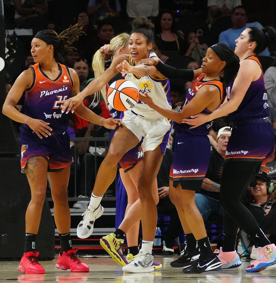 July 28, 2022;  Phoenix, Arizona; USA; Sparks forward Olivia Nelson-Ododa (10) gets tied up for a jump ball with Mercury guard Shey Peddy (11) during a game at the Footprint Center.