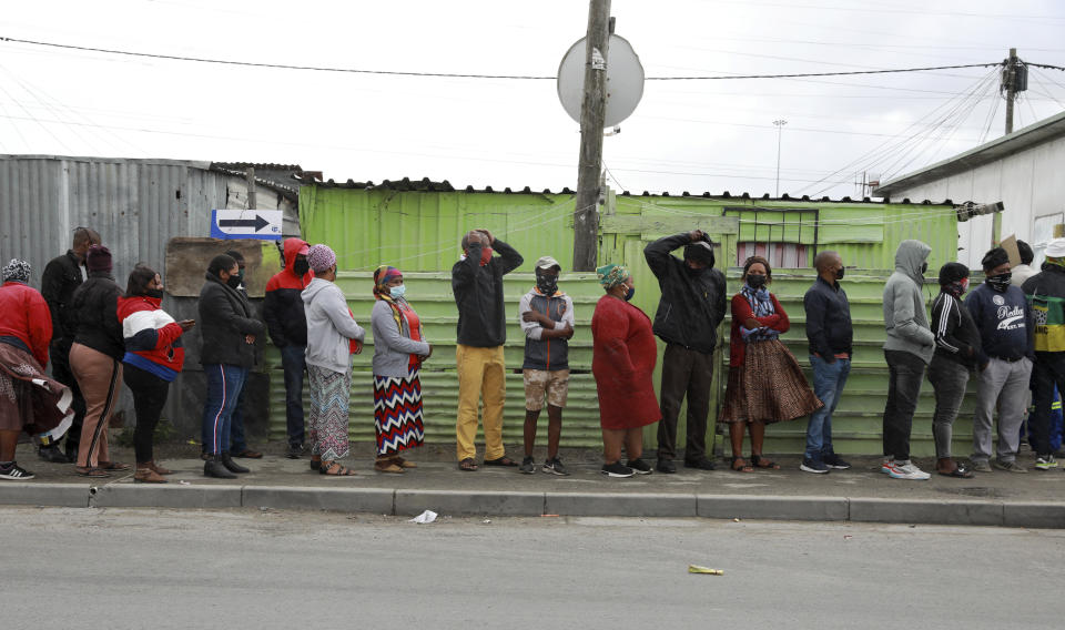 FILE - People queue outside a polling station in Khayelitsha in Cape Town, South Africa, Monday, Nov. 1, 2021. In South Africa, a tarnished democratic beacon, the long-dominant African National Congress faces mounting social problems and voter disillusionment in an election due between May and August. (AP Photo/Nardus Engelbrecht, File)