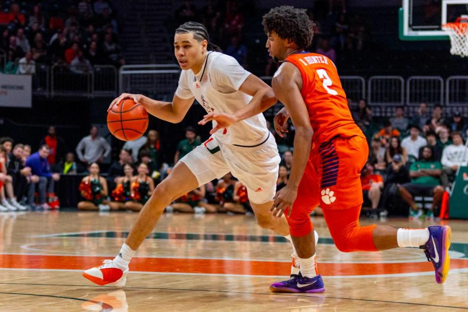 Miami Hurricanes guard Kyshawn George (7) drives on University of Clemson guard Dillon Hunter (2) during the second half of an NCAA basketball game at the Watsco Center in Coral Gables, Florida, on Wednesday, January 3, 2024.