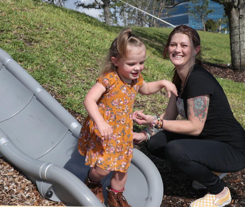 Angela Bennardo said she struggled with the Medicaid system at multiple points in her two pregnancies. She had difficulty signing up for Medicaid online, trouble getting someone on the phone to answer her questions, and more challenges matching her insurance to an obstetrician who could accept her plan and help someone in recovery from addictions. She's pictured with her 2-year-old daughter Addi Barry at the Riverfront Esplanade in Daytona Beach.