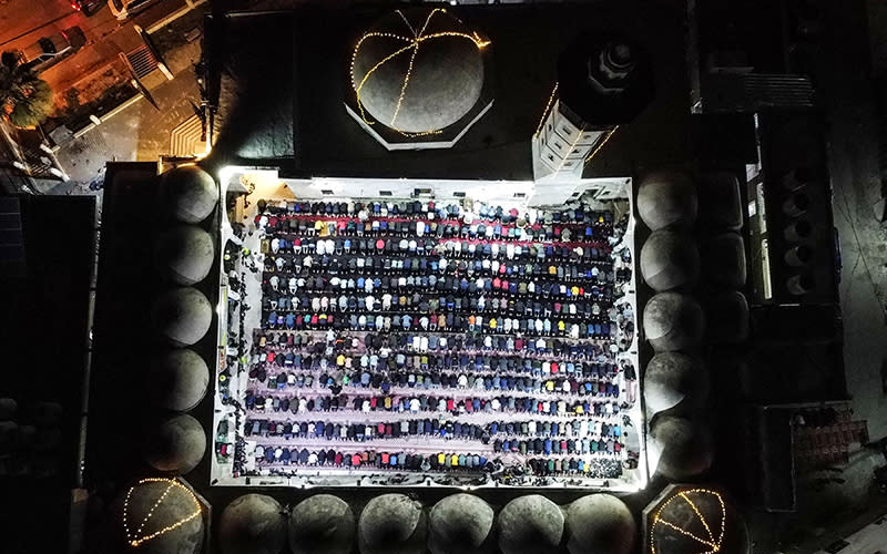 Palestinian devotees pray during Laylat al-Qadr during the Islamic holy month of Ramadan at Sayed al-Hashim Mosque in Gaza City on April 28. <em>Mahmud Hams/AFP/Getty Images</em>