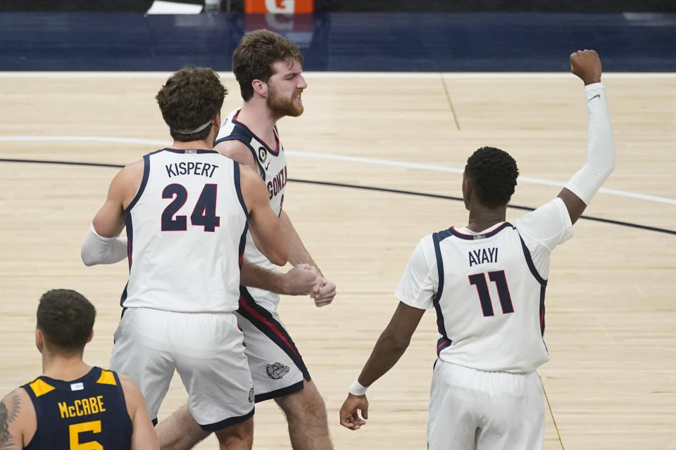 Gonzaga's Drew Timme (2) celebrates with Corey Kispert (24) and Joel Ayayi (11) after Timme made a shot and was fouled during the second half of the team's NCAA college basketball game against West Virginia, Wednesday, Dec. 2, 2020, in Indianapolis. (AP Photo/Darron Cummings)