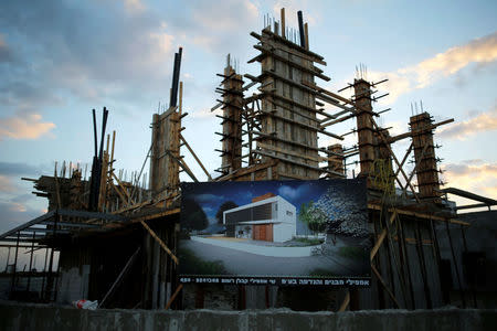 A billboard advertising the construction of a house is displayed in front of the site in the new neighbourhood of Carmei Gat in the southern Israeli city of Kiryat Gat November 1, 2016. REUTERS/Amir Cohen