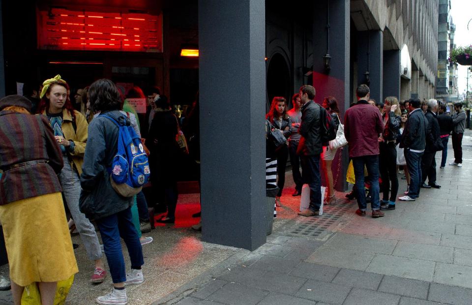 FOR STORY DINING DELAYS - Customers form a shambolic queue as they wait to be seated in the Meat Liquor restaurant on Welbeck Street in central London, around 20:30 on Tuesday, July 10, 2012, which is currently one of London's busiest destinations for burgers and cocktails. The Meat Liquor restaurant has a no-booking policy which means queues often form outside as customers wait to sample the food and the atmosphere at one of the capital's most sought after destinations. (AP Photo/Joel Ryan)