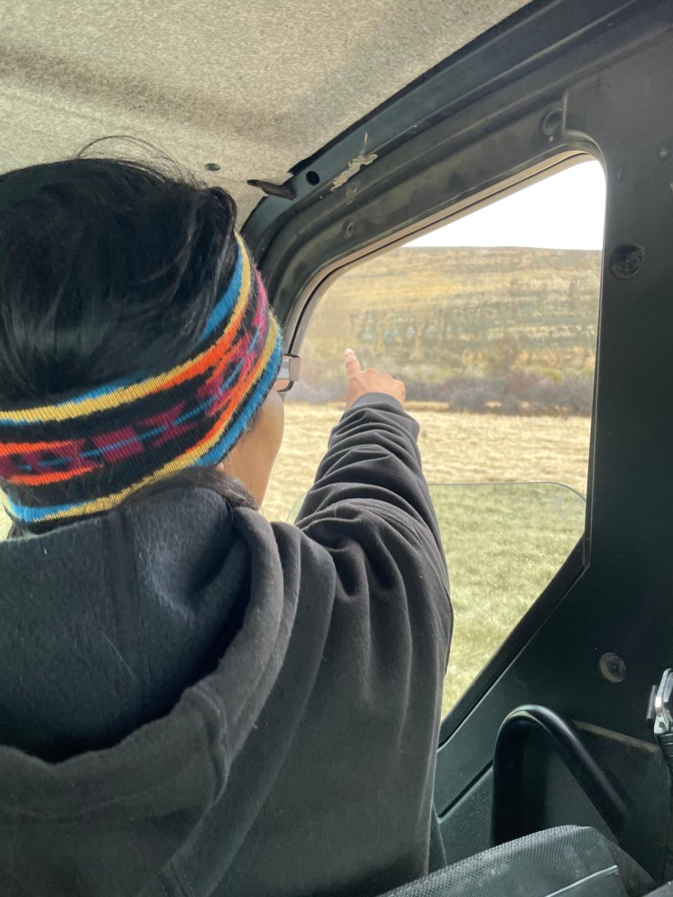 Colleen Bell, enrolled Eastern Shoshone, points toward a faraway group of buffalo