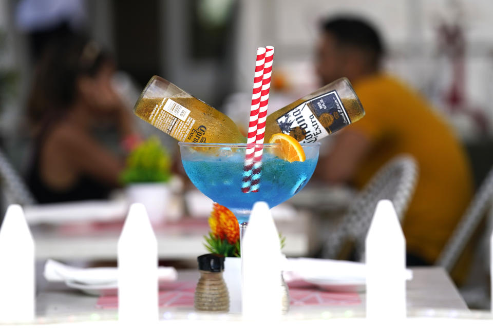 A drink is displayed at the Boulevard Restaurant along Ocean Drive, Friday, Sept. 24, 2021, in Miami Beach, Fla. For decades, this 10-block area has been one of the most glamorized spots in the world, made cool by TV shows like Miami Vice, where the sexiest models gathered at Gianni Versace's ocean front estate and rappers wrote lines about South Beach's iconic Ocean Drive. (AP Photo/Lynne Sladky)
