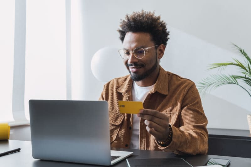 Smiling businessman making payment with credit card