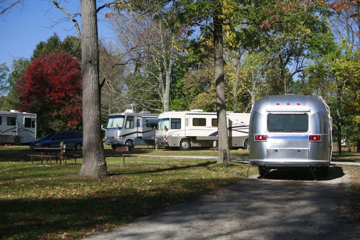 Class A Motor Homes and Travel trailers camp in the early autumn.