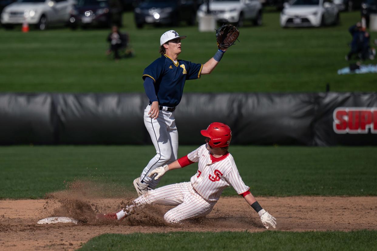 St. John's Pearson Dodds steals second ahead of the throw to Xaverian's Jackson Morse.