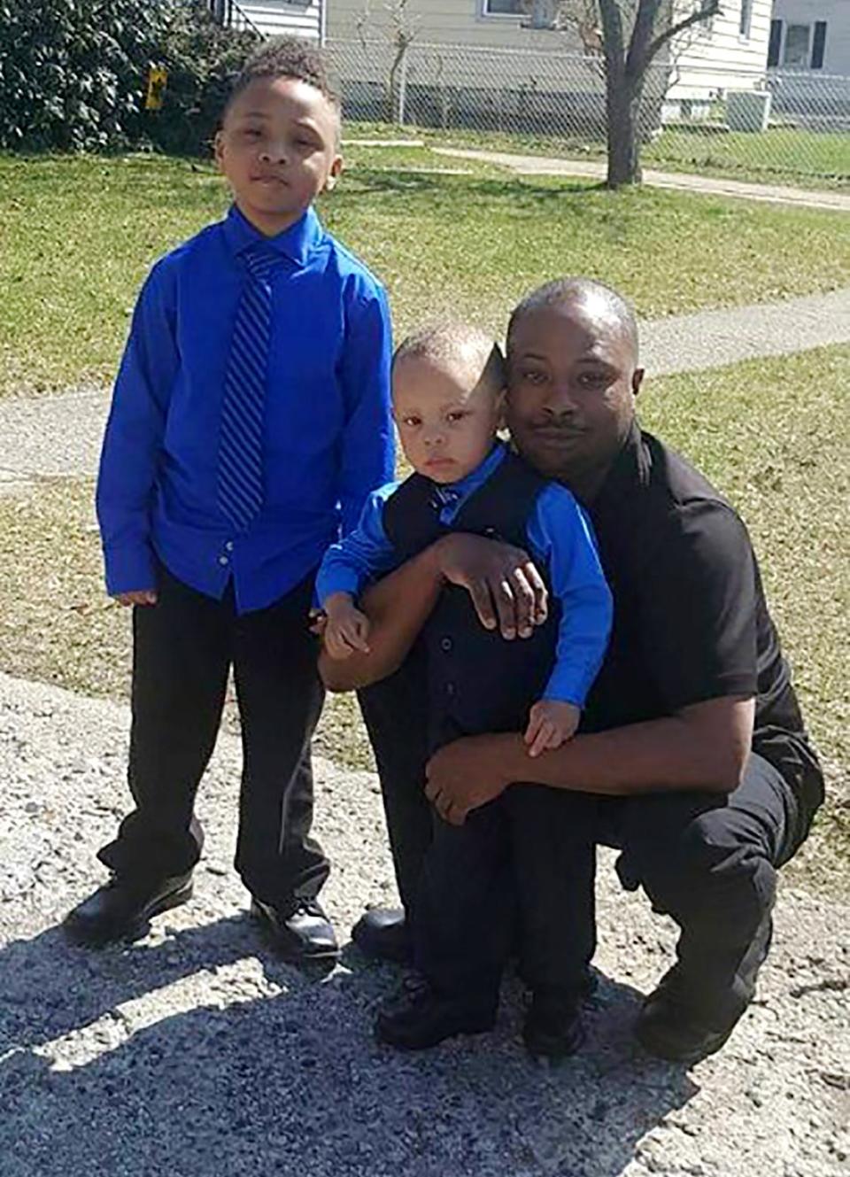 DeAndre Mitchell of Flint poses in this undated photo with his sons, LaMar  Zy’Aire, who died in a May 28, 2022 fire at their father's home.