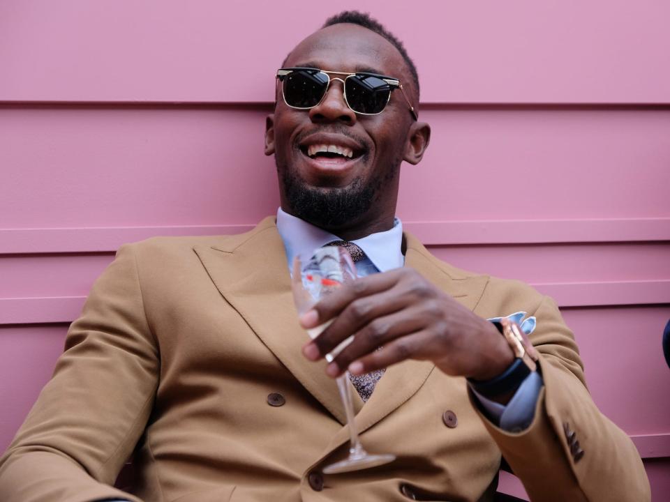 Usain Bolt smiles at the Oaks Day at Flemington Racecourse in 2019.