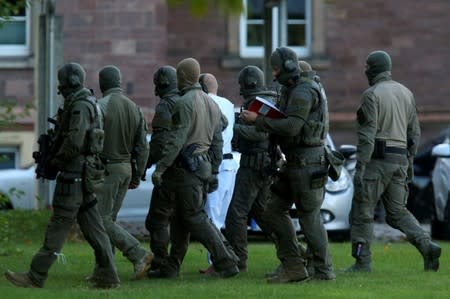 German special police escorts Stephan B. prior to a hearing at the Federal Court in Karlsruhe