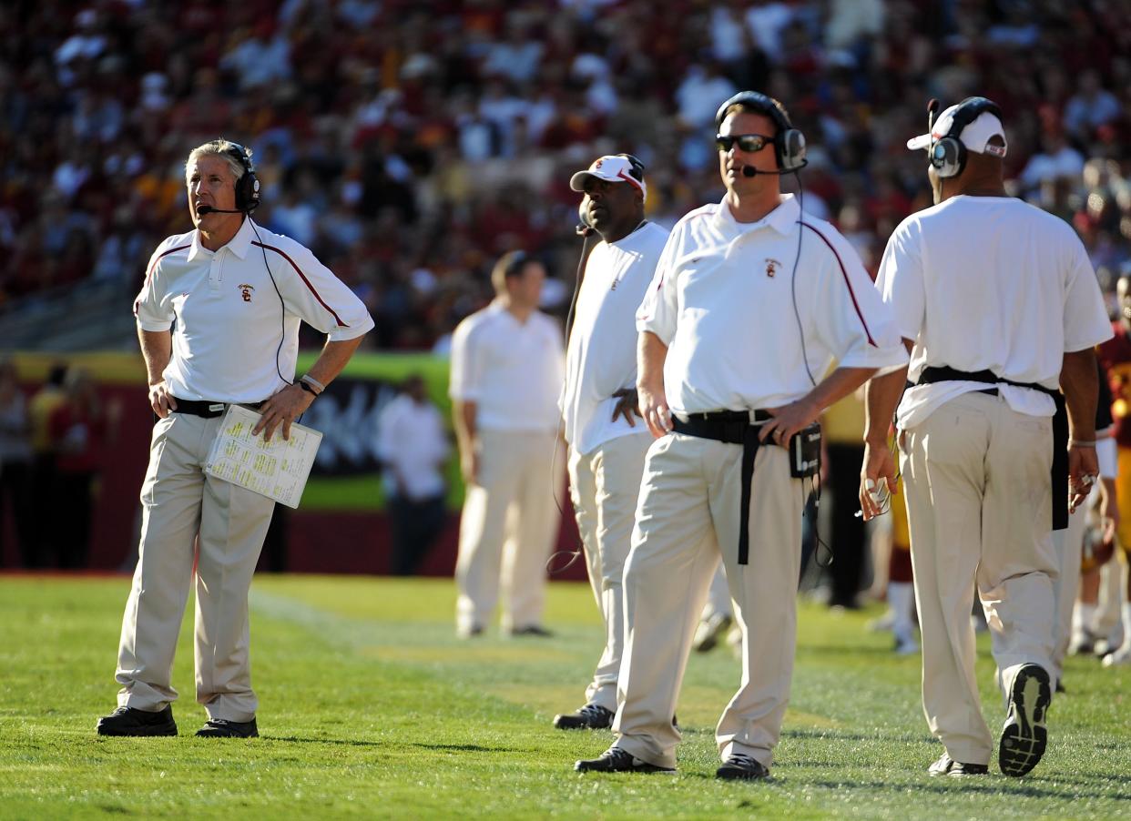 Pete Carroll and Lane Kiffin roamed the sidelines at USC together. Kiffin didn't find the success that Carroll did during his time in Los Angeles. (Harry How/Getty Images)